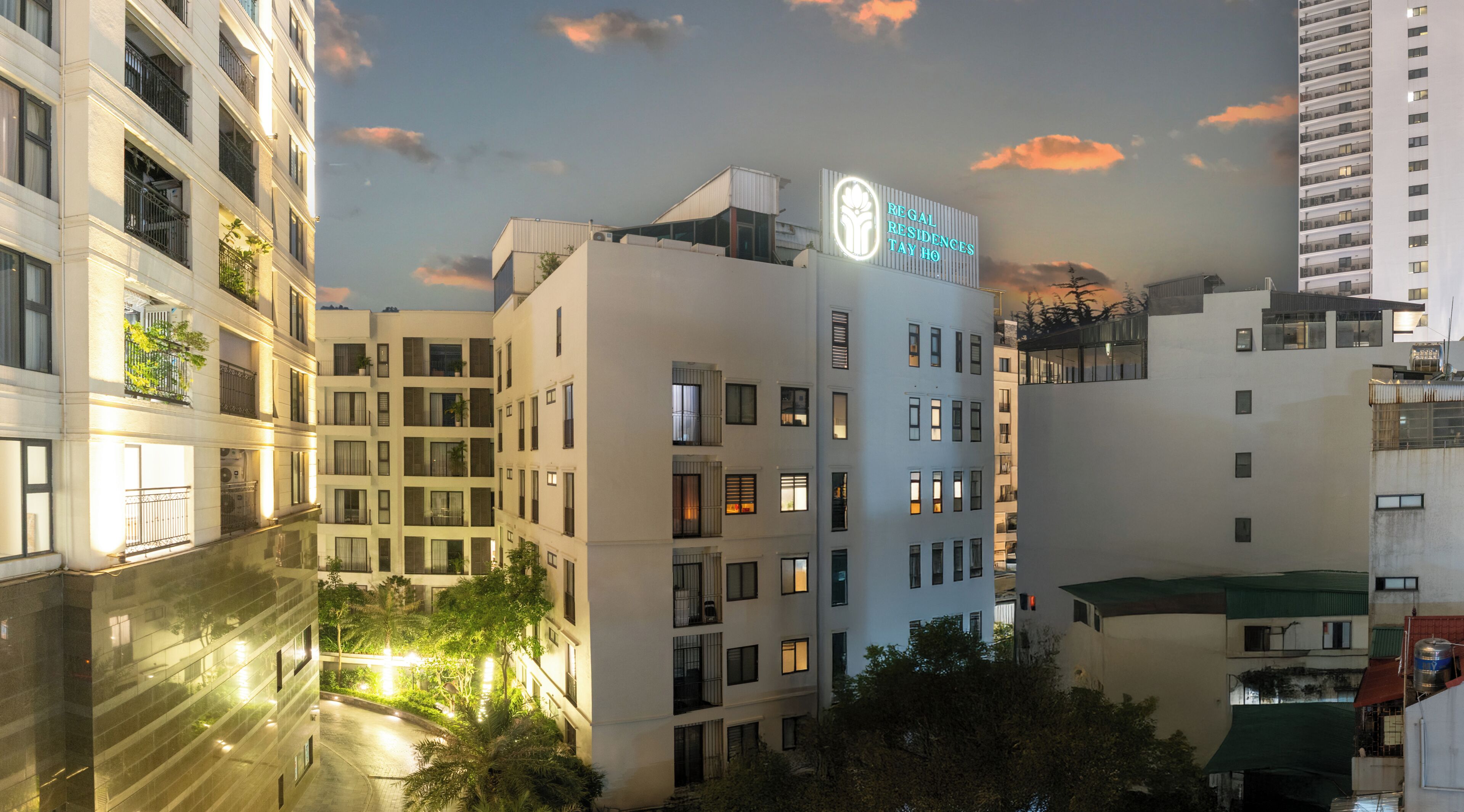 A multi-story hotel building with a sign indicating 'Regal Residences Tay Ho'.