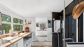 A compact kitchen with a sink, countertop, and window.