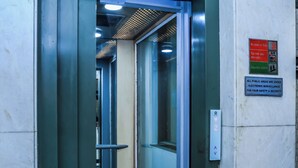 An elevator with a red carpet leading to a hallway. - asar CP Outer Circle by Orion Hotels (New Delhi)