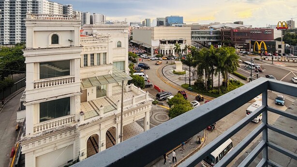 A cityscape with a prominent McDonald's and a large cinema complex. - Serene Getaway with Prime Emperador View (Iloilo City)