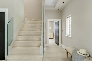 A staircase with a glass railing leading to a landing. - Gable View (Combeinteignhead)