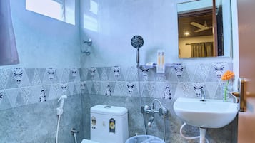 A compact bathroom with a toilet, bidet, and sink.