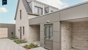 A modern building with a brick facade, a flat roof, and a small garden area with flowers. - Löning 1 - Modern vacation home with sauna, terrace & WLAN - close to the beach on Usedom (Ückeritz)