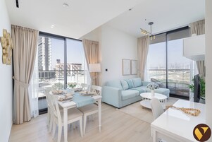 Luxury Apartment | Living area | 55-inch Smart TV with satellite channels