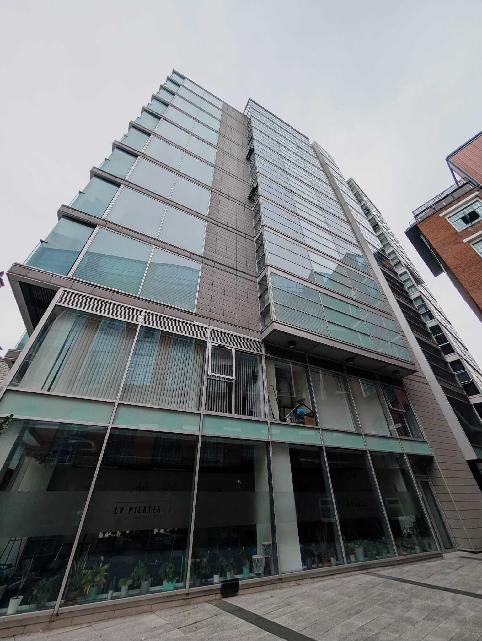 A multi-story building with large glass windows and a modern architectural design.