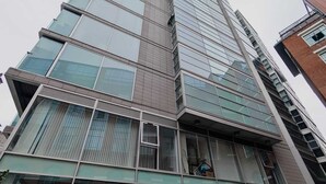A multi-story building with large glass windows and a modern architectural design.