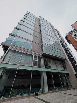 A multi-story building with large glass windows and a modern architectural design.