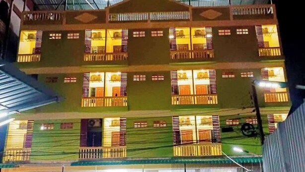 A multi-story building with balconies and a central entrance. - Natcha Place Klongluang 35 (Khlong Luang)