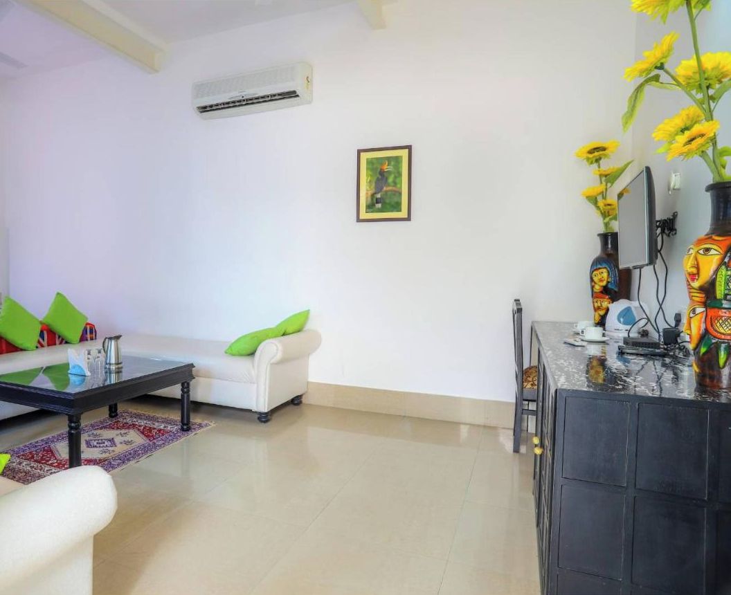 A modern living room with a sofa, a coffee table, and a TV stand with decorative items.
