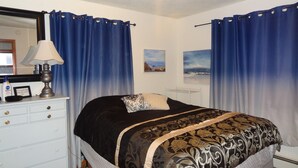 A bedroom with a bed, a dresser, a lamp, and curtains. - Across from St Marys hospital Covered By Faith 1 (Rochester)