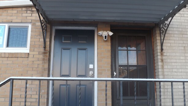 A residential building with a dark blue front door, a small porch with a metal railing, and a brick facade. - Across from St Marys hospital Covered By Faith 1 (Rochester)