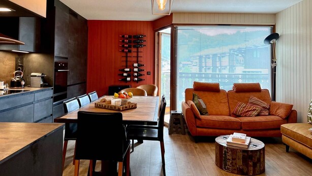 A modern living space with a dining area, kitchen, and seating area. - 3-room Apartment 5 guests - South Terrace, Garage, WiFi, Near shops (Les Gets)
