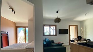 A modern, open-plan living space with a bed, sofa, and dining area. - Modern 2-room apartment + cabin, 4 persons, parking (Cohennoz)