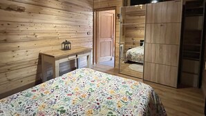A wooden room with a bed, a desk, and a wardrobe. - Châtel: 3-Room Apt, Terrace, 5 Pers, Private Parking (Châtel)