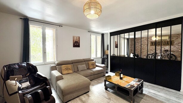 A modern living room with a sofa, a massage chair, a coffee table, and a large window with curtains. - The Loft Factory 4 Bedrooms Garonne View + Garden (Lormont)
