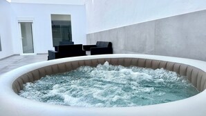 A hot tub with water bubbling in a modern outdoor setting. - The White House (Santa Lucía de Tirajana)