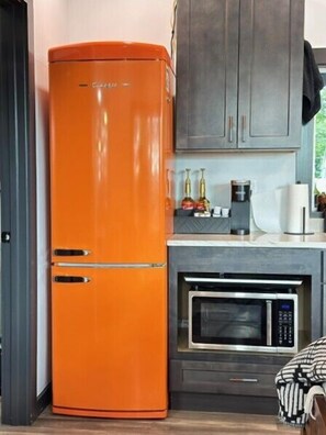 Fridge, microwave, coffee/tea maker, cookware/dishes/utensils