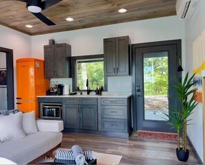 Fridge, microwave, coffee/tea maker, cookware/dishes/utensils