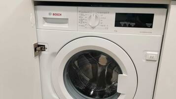 A Bosch washing machine in a kitchen setting.