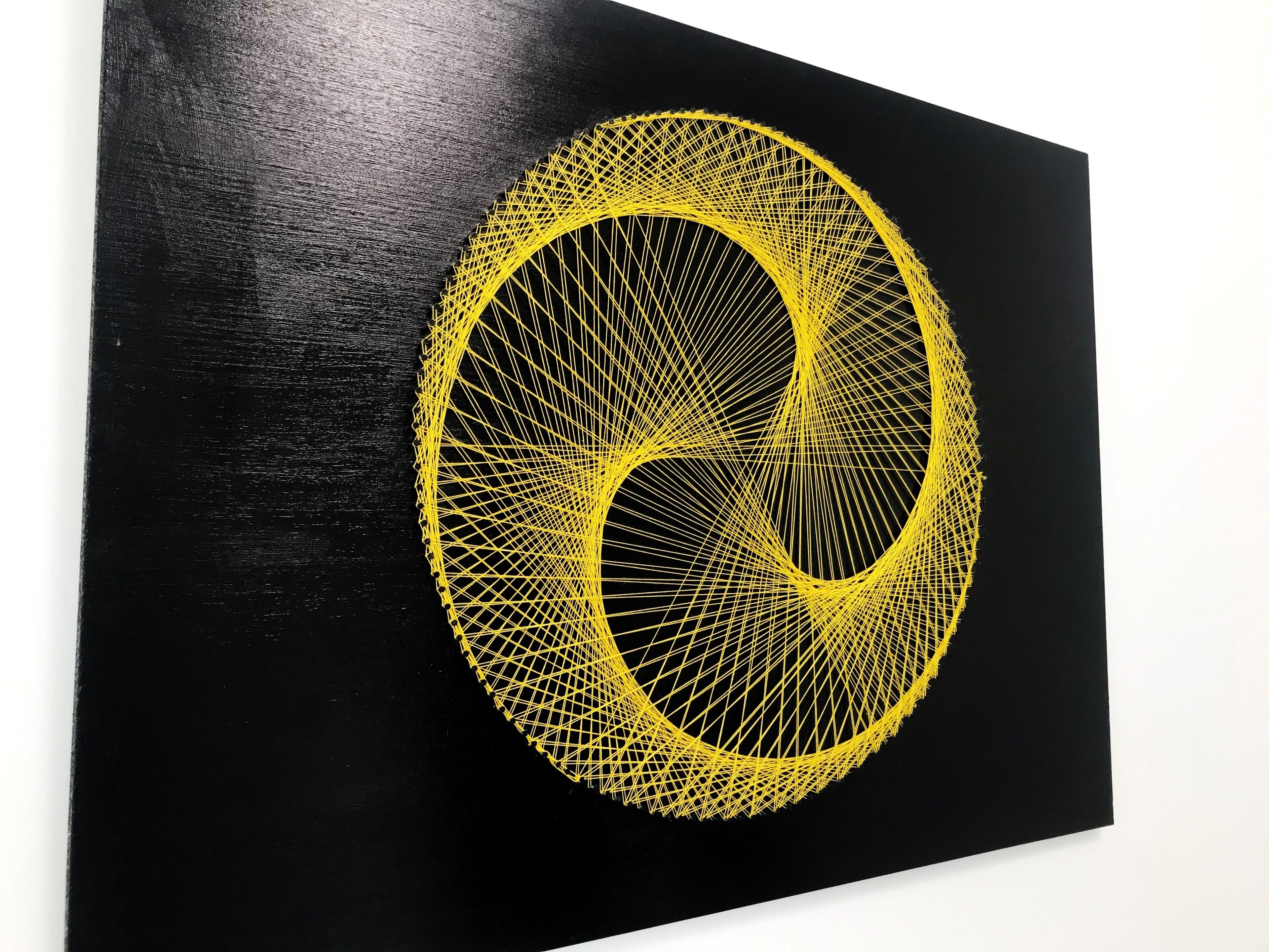 A black wall with a yellow geometric design.