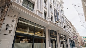 A hotel with a classic facade, large windows, and a prominent entrance. - Elysia Hotel (Istanbul)