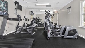 A gym with treadmills, stationary bikes, and ellipticals. - Cozy Contemporary Stay I Pool & Gym I Free Parking (Fayetteville)