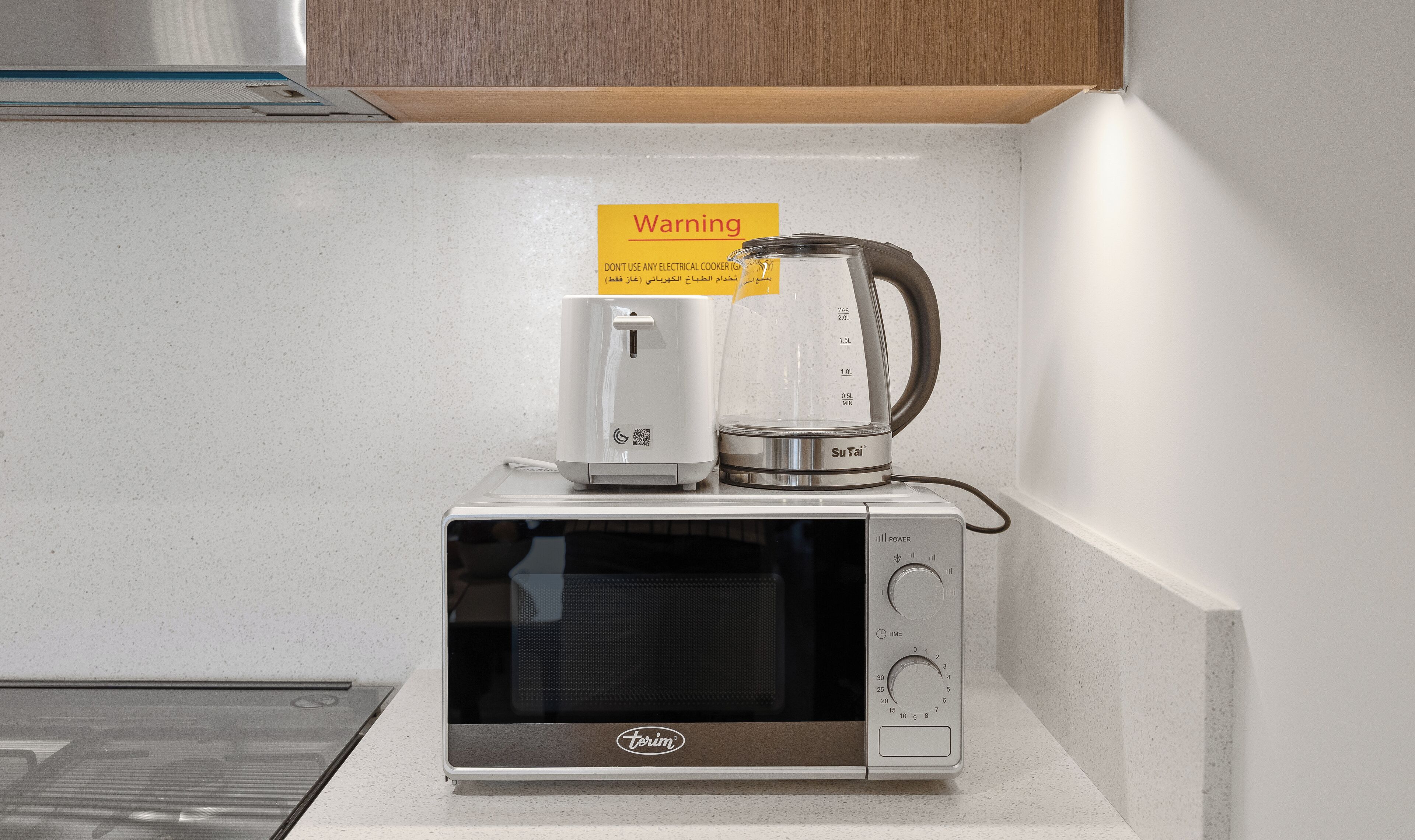 A compact microwave oven with a glass container on top, a power button, and a timer.