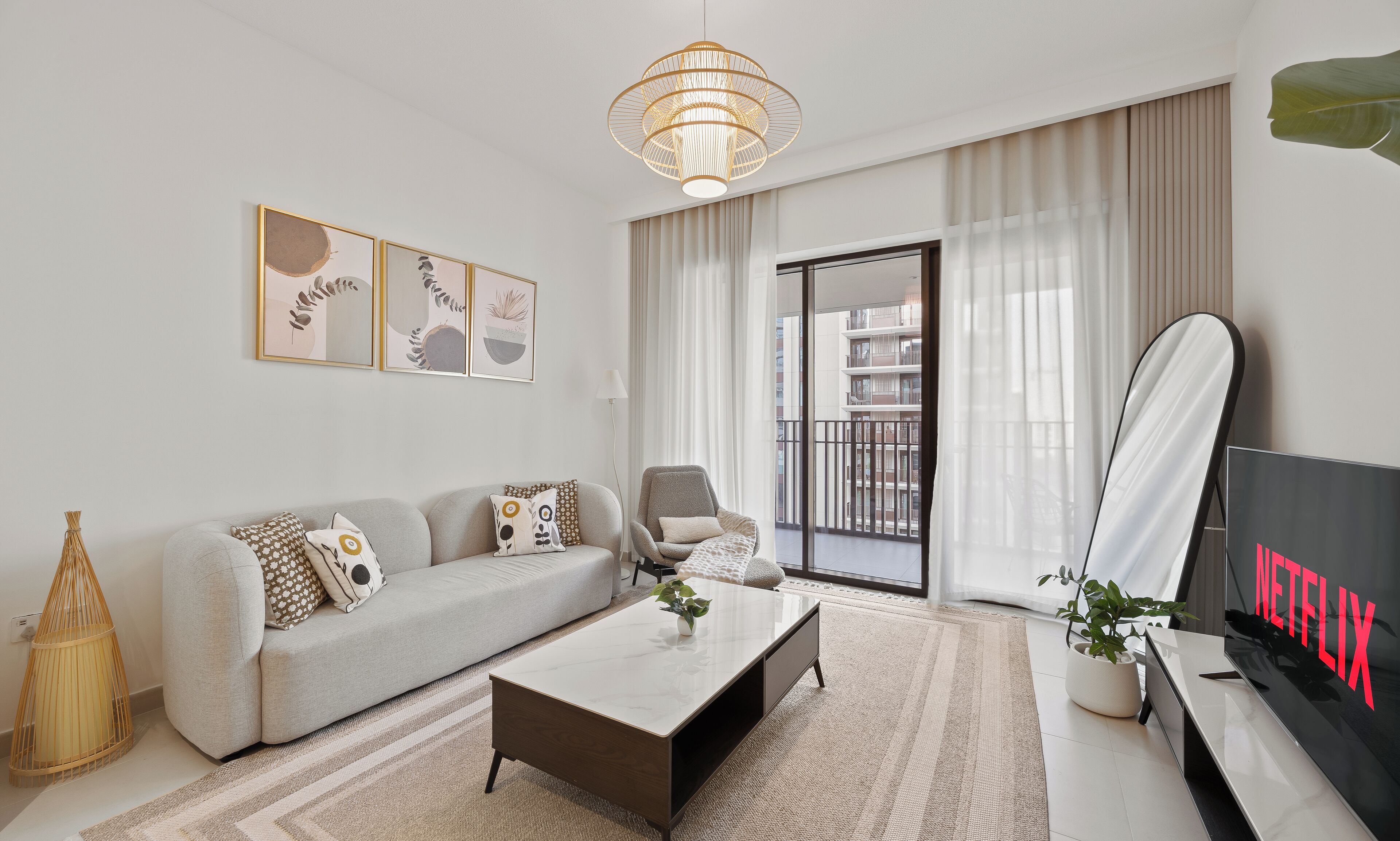 A modern living room with a sofa, coffee table, and a TV displaying 'NETFLIX'.