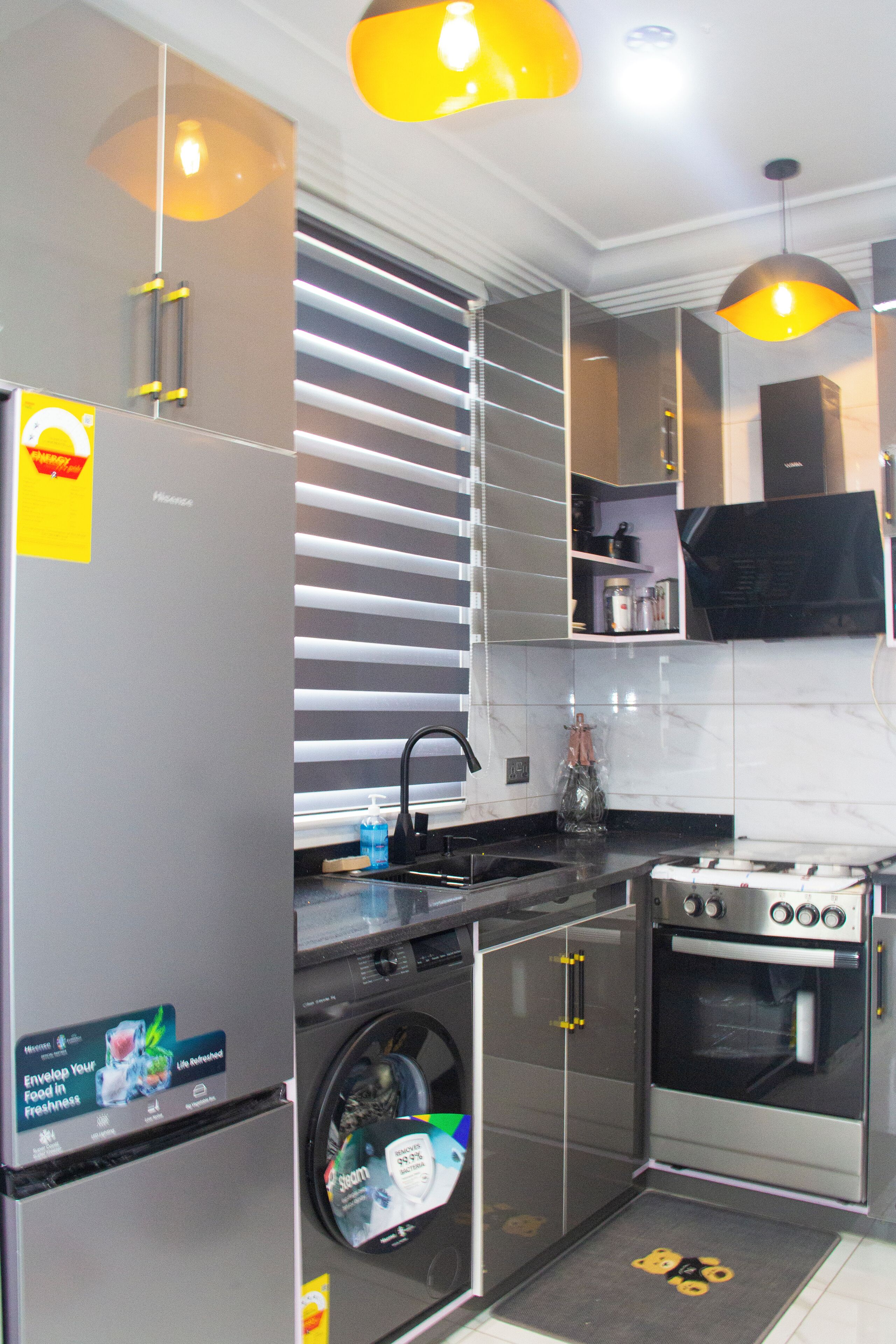 Una cocina moderna con electrodomésticos de acero inoxidable, horno empotrado y lavavajillas.