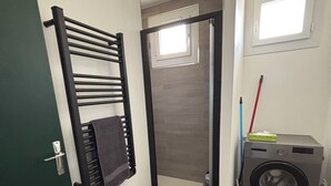 A compact laundry room with a washing machine, a drying rack, and a small window. - Nature & jacuzzi, near Sancerre, Guedelon, Lac de Bourdon, St Fargeau, Pouilly (Cosne-Cours-sur-Loire)