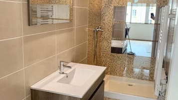 Shower, hair dryer, towels, toilet paper