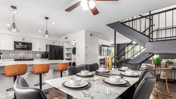 A modern kitchen with white cabinets, a black refrigerator, and a marble countertop. - Walk to Old Town & Giants Stadium! Unit w/ Pool (Scottsdale)
