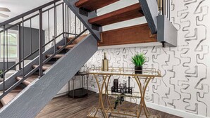 A staircase with a metal railing, a wooden handrail, and a patterned wall. - Walk to Old Town & Giants Stadium! Unit w/ Pool (Scottsdale)