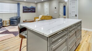A modern kitchen with a large island, built-in appliances, and a dining area with a sofa and chairs. - Hike & Ski: Condo 8 Mi to Dtwn Salt Lake City! (Salt Lake City)