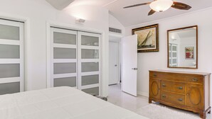 A bedroom with a bed, a dresser, a mirror, and a door with frosted glass panels. - 2 Mi to Fsu: Unique Home w/ Patio & Spacious Yard (Tallahassee)