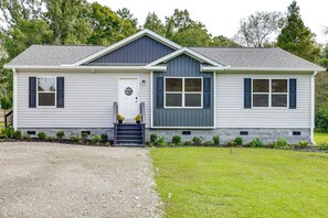A single-story house with a front porch, a garage, and a small front yard. - Screened Porch: Family-friendly St Stephen Retreat (St. Stephen)