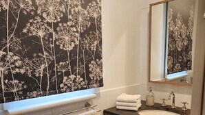 A bathroom with a vanity, a sink, a mirror, and a towel rack. - Bowen Toft Villa- home-from-home (FIFO friendly) (Sandy Bay)