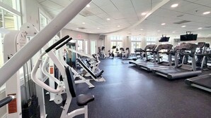 A gym with various exercise equipment, large windows, and a ceiling with recessed lighting. - 5 Corner Store Ln Sunset Island | Resort Community (Ocean City)