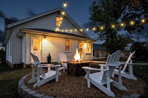 A house with a fire pit and outdoor seating.