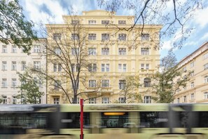 A multi-story building with a classical architectural style, featuring a symmetrical facade with evenly spaced windows and decorative moldings.