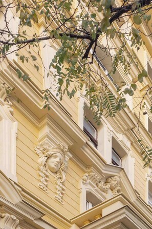 A building facade with ornate architectural details, including carved stonework and a classical design.