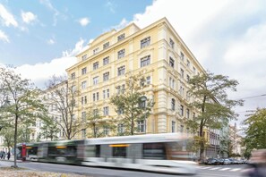 A multi-story building with classical architecture, featuring a symmetrical facade, large windows, and a central entrance.