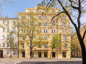 A multi-story building with a classical architectural style, featuring symmetrical windows and ornate detailing.