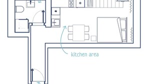 Un plan d’étage comprenant une salle de bain, un coin cuisine et une entrée.