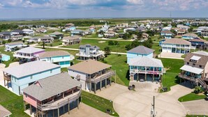 A residential area with houses featuring balconies and attached garages. - Sea Glass Retreat 3 Bedroom Home (Port Bolivar)