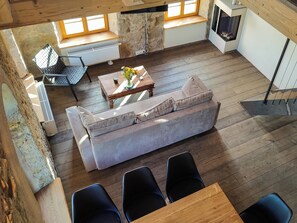 A modern interior with a sofa, chairs, a table, and a fireplace. - Private sauna, 2 fireplaces: Bright 3-bedroom flat (Großharthau)