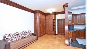 Standard Apartment | Living area | 59-inch flat-screen TV with cable channels