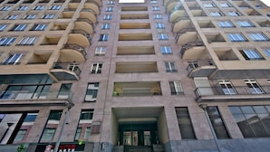 A high-rise apartment building with multiple balconies, large windows, and a central entrance. - North Ave. apartment by Luxe Group HH777 (Yerevan)