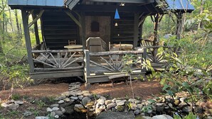 A rustic wooden cabin with a porch, stone pathway, and a small stream. - Rustic Log Cabin- In Town Cashiers- Pet-Friendly! (Cashiers)