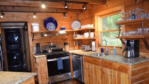 A wooden cabin kitchen with a stove, oven, dishwasher, and granite countertop. - Rustic Log Cabin- In Town Cashiers- Pet-Friendly! (Cashiers)